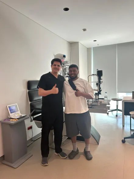 A patient and his coordinator beside the slit-lamp examination unit at our partner hospital in Istanbul