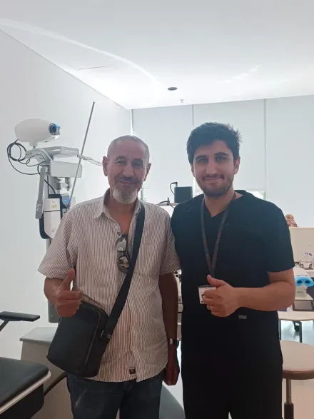 A patient with his Eyeglow Health coordinator in the ophthalmic examination room in Istanbul