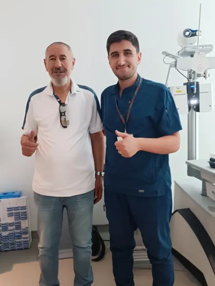 A patient with a member of the clinical team after an eye assessment in Istanbul