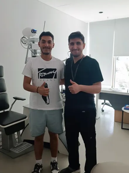 A patient and his Eyeglow Health coordinator in the eye examination room in Istanbul