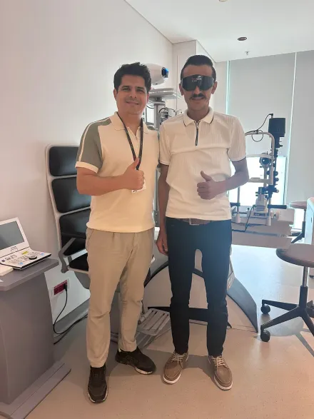 A patient wearing post-operative protective glasses, with his coordinator in Istanbul